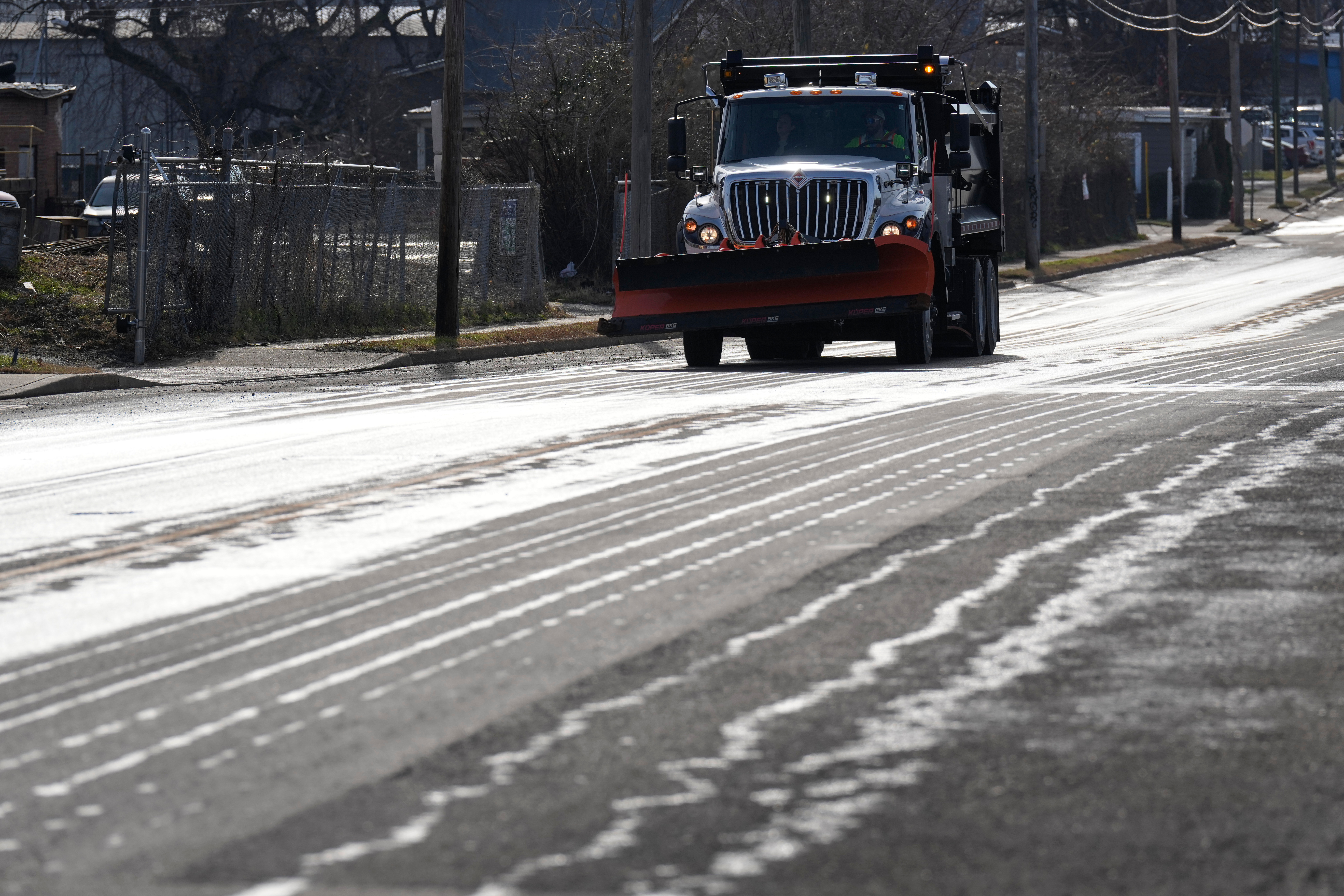 Crews spread salt on roads and people stock up on batteries as a winter ...